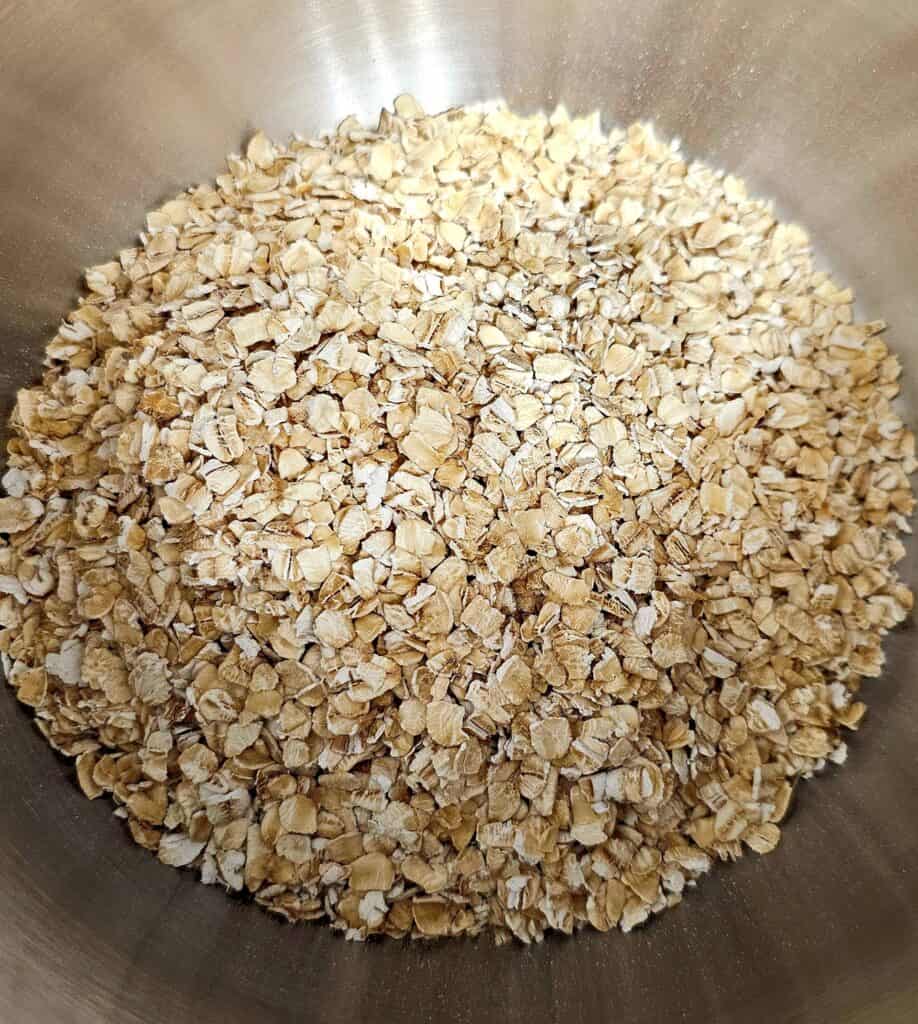 1/2 cup of dried quick oats sitting in a small stainless steel pot