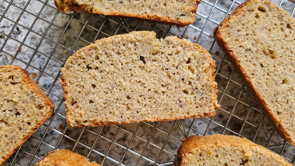 a piece of banana bread that is sliced face up so you can see the crumb of the bread