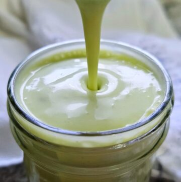Quick Creamy Avocado Dressing Recipe (Vegan Option) being poured into a mason jar