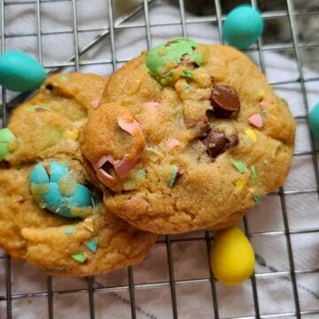 Cadbury mini egg cookies sitting on a cooling rack
