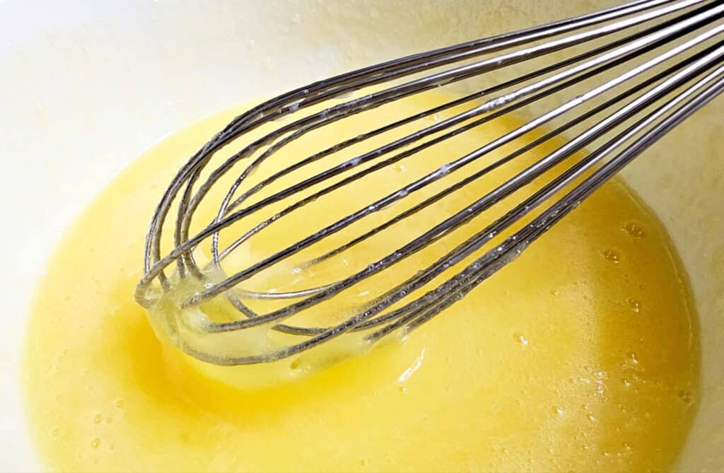 wet batter with a whisk in it