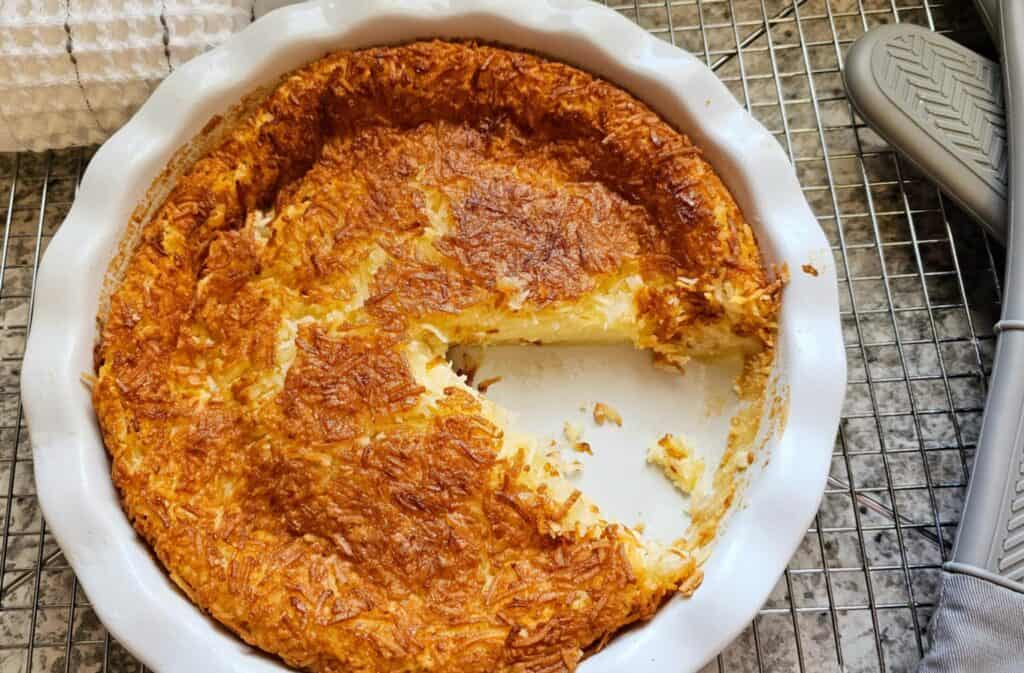 a delicious Impossible Coconut Pie Recipe (without bisquick) with custard filling and golden coconut topping 