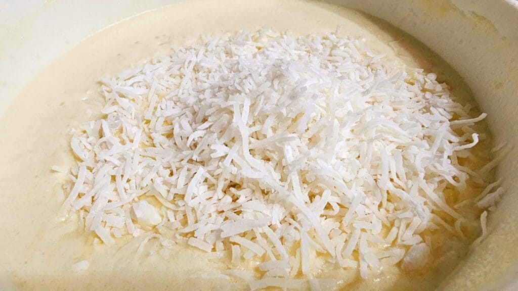 shredded coconut on impossible pie batter