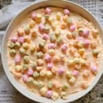 Easter Fluff in a white bowl made with cool whip, canned fruit, marshmallows and cottage cheese