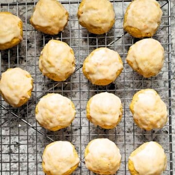 Carrot cookies with an orange glaze on a wire rack