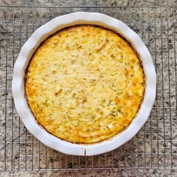 chicken and rice casserole in a pie dish cooling on a cooling rack