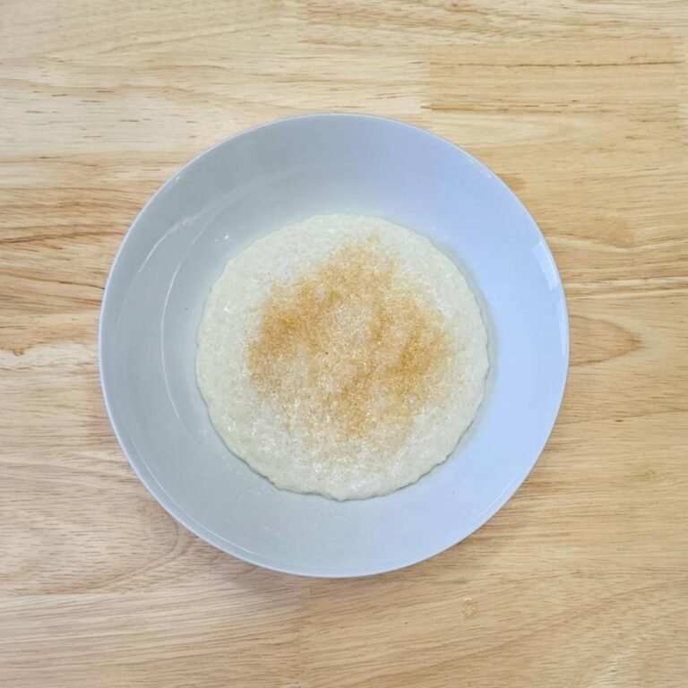 creamy rice cereal in a bowl with a wooden background