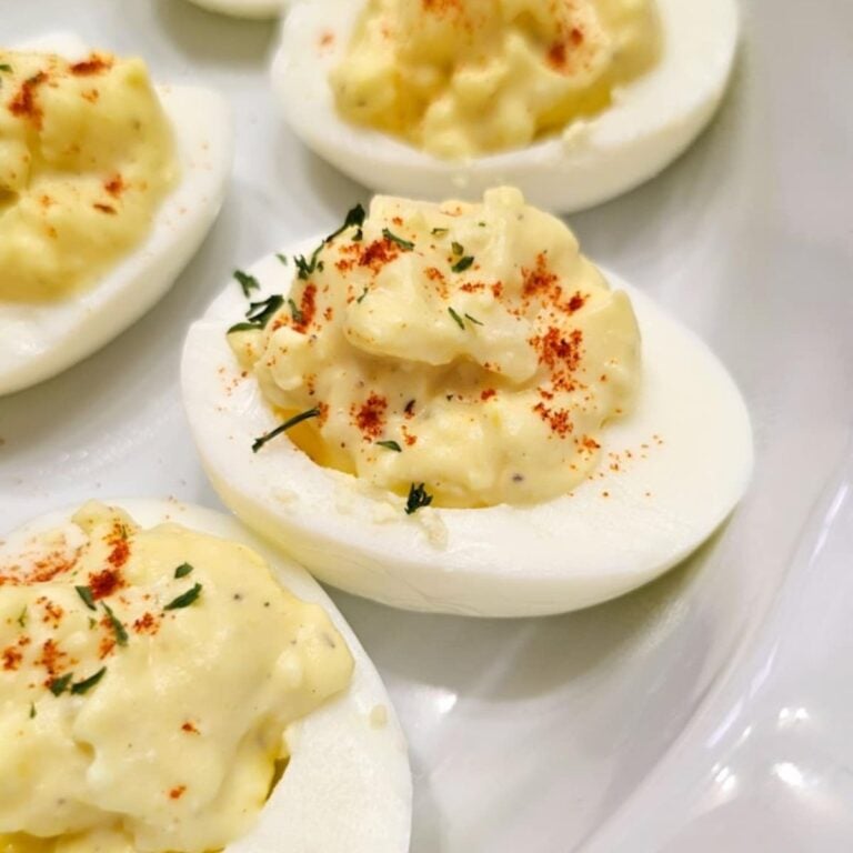 deviled eggs sprinkled with paprika and parsley