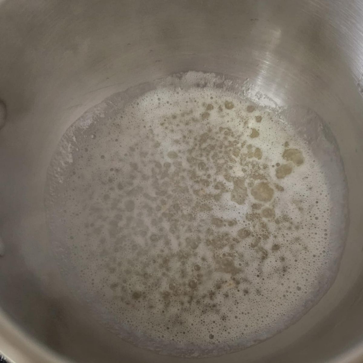 butter boiling in a stainless steel pot