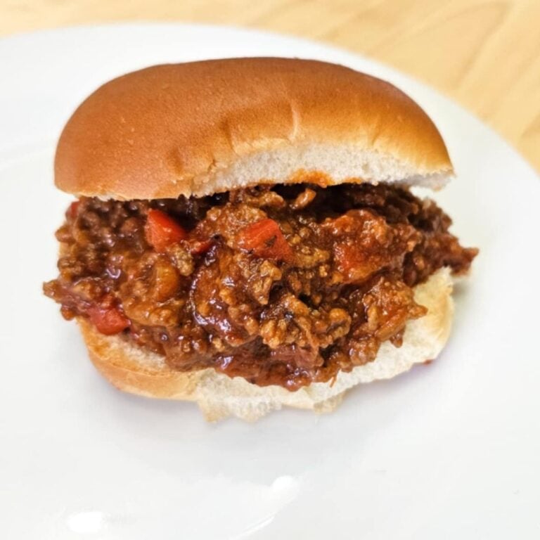 sloppy joes on a bun on a white plate