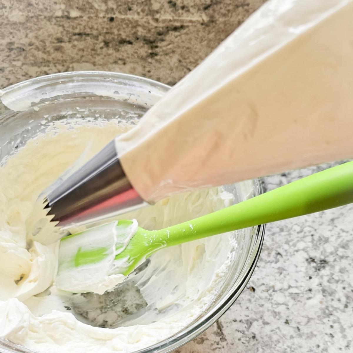 cream cheese whip cream in a piping bag