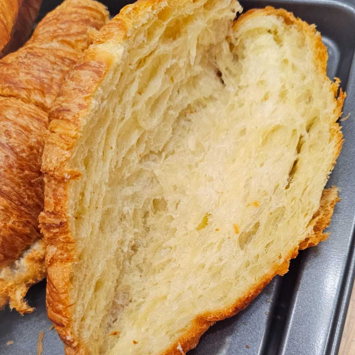 croissant sliced in half to make strawberries and cream croissants