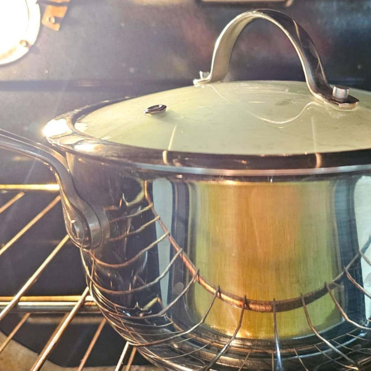 lid on a pot of hot milk sitting in the oven with the oven light on to keep it warm