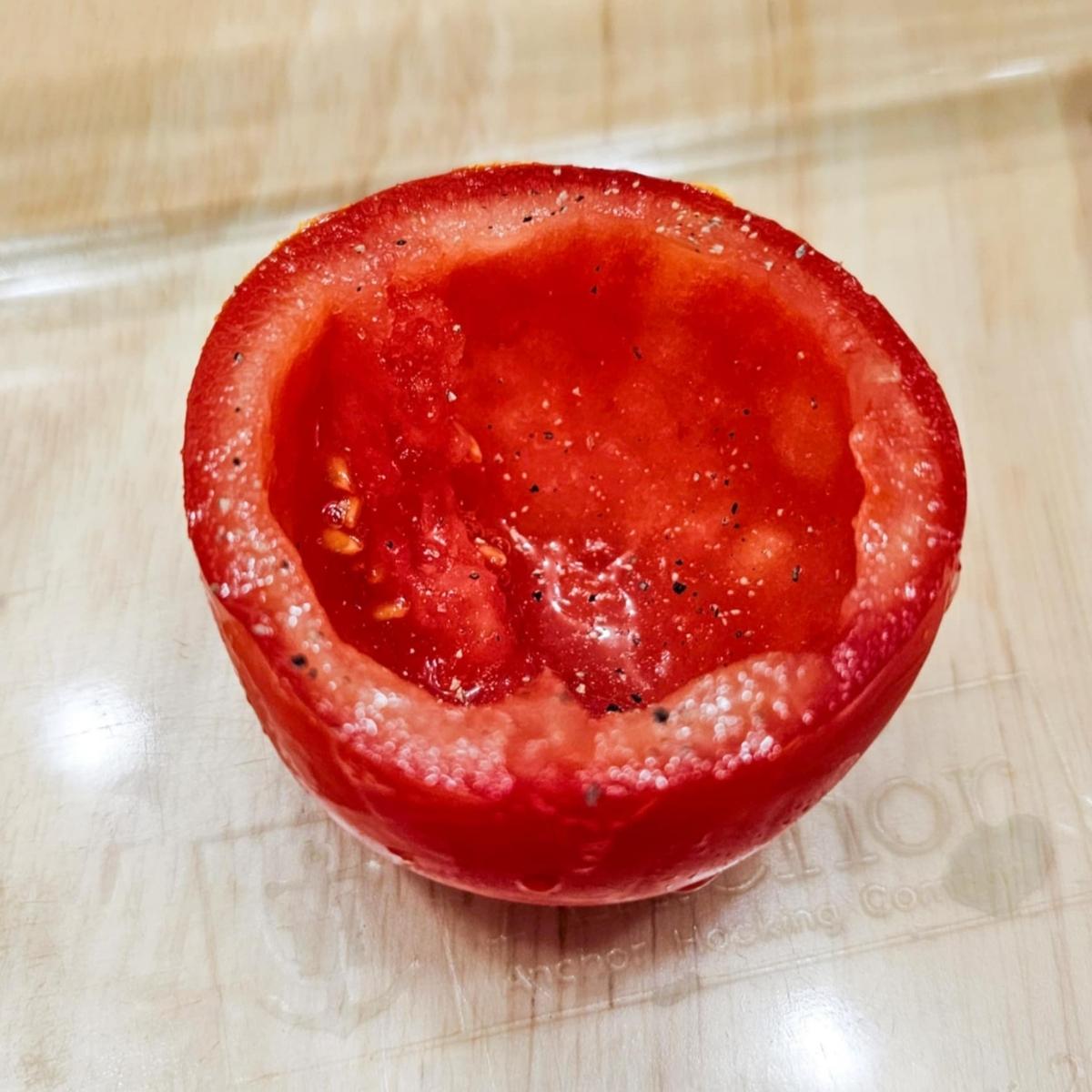 tomato with the top cut off and cavity emptied and salt and peppered