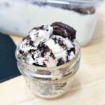 oreo ice cream in a mason jar on a wooden counter top