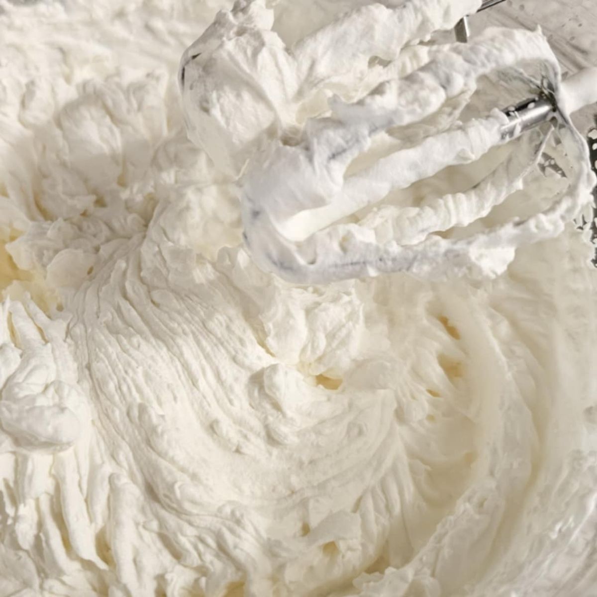 homemade whip cream, whipped up in a bowl with electric beaters