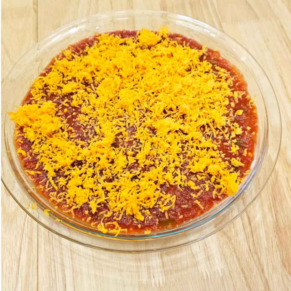 simple nacho dip topped with shredded cheese