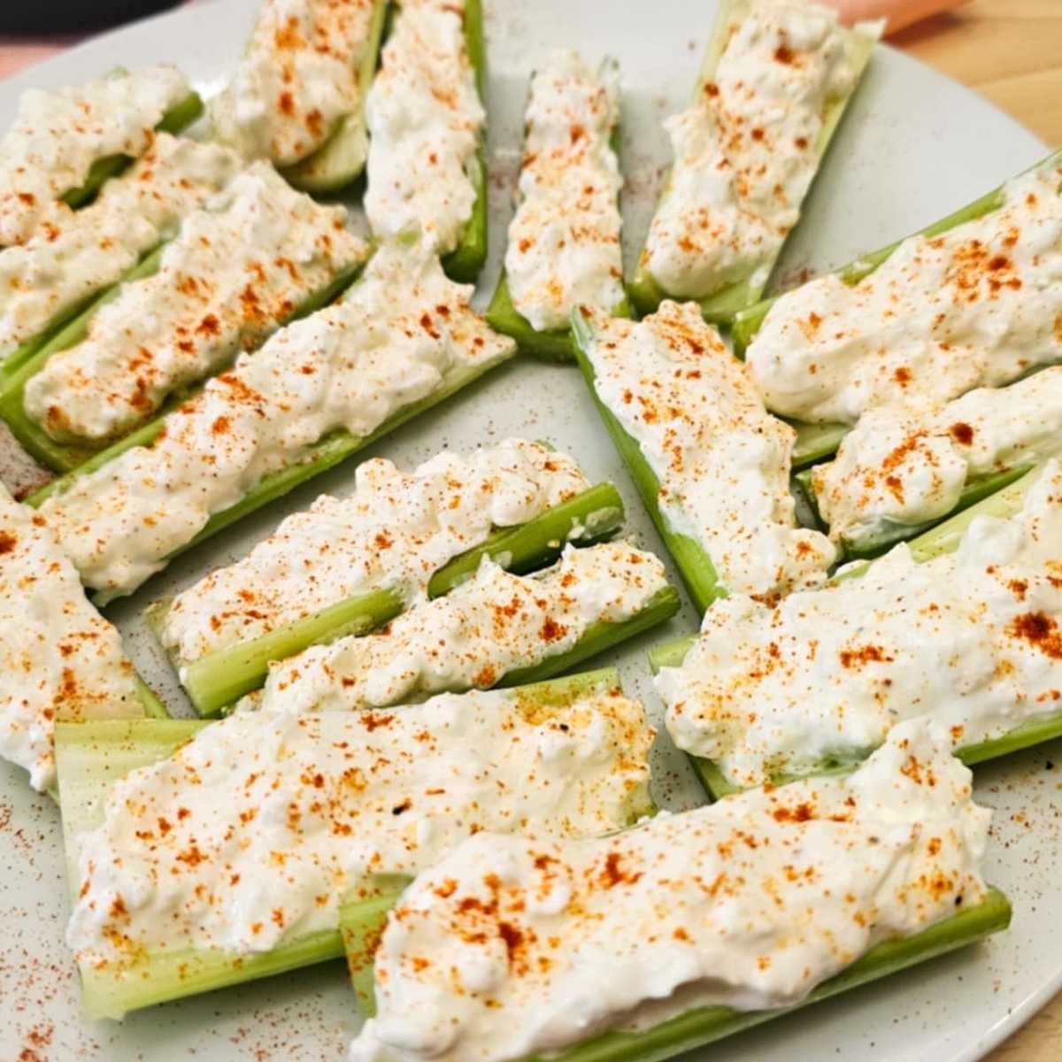 1950's stuffed celery topped with paprika in a large deep pie dish