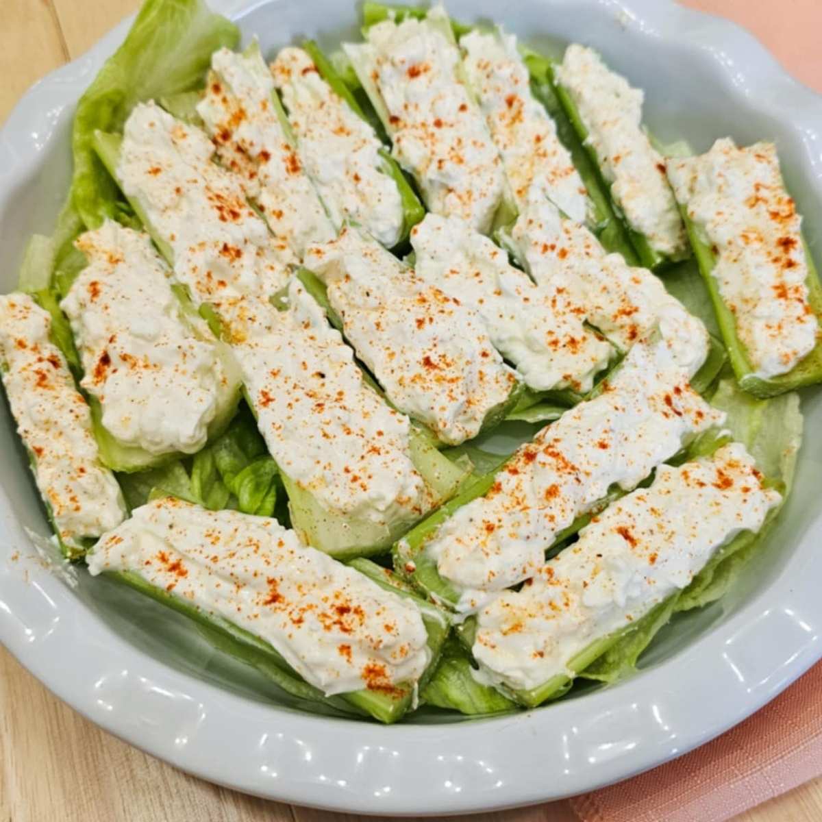 celery with cream cheese and cottage cheese on a bed of lettuce