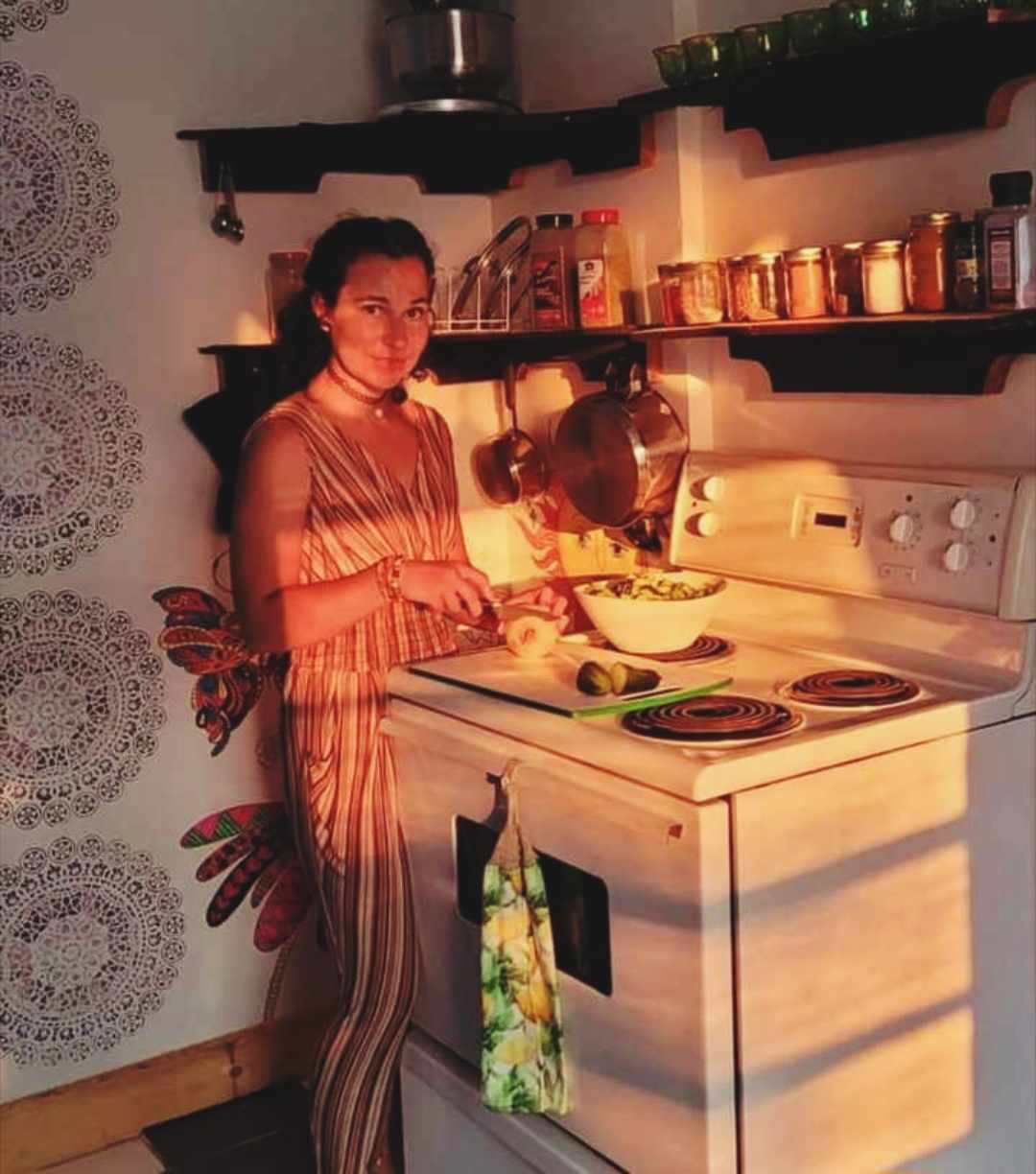 the happy homemaker standing next to the oven