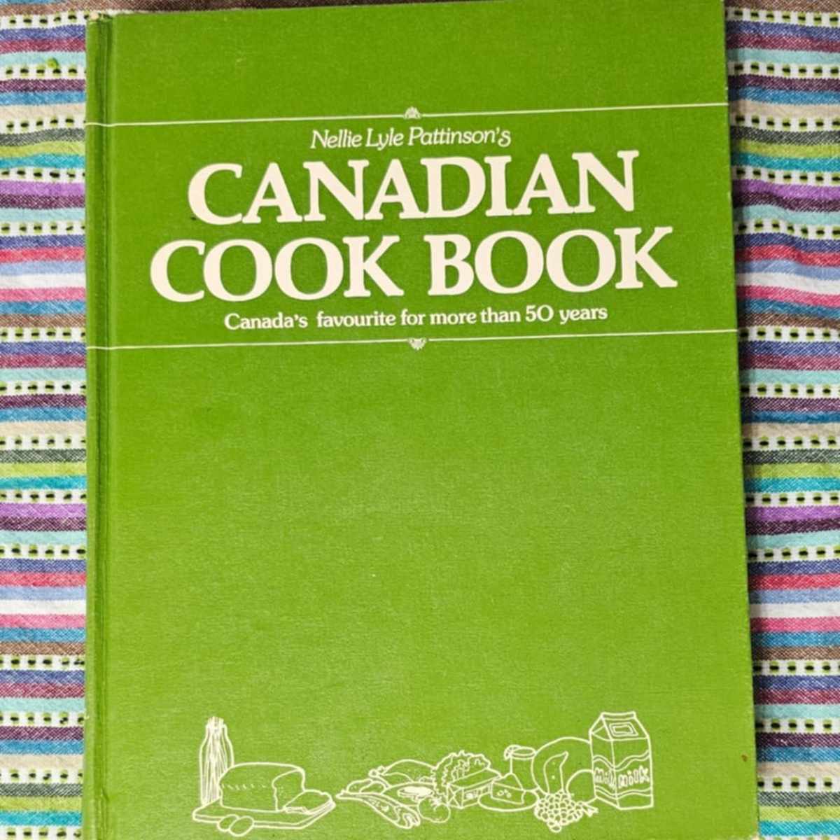canadian cook book by nallie lyle pattinson  cook book on a colourful table cloth