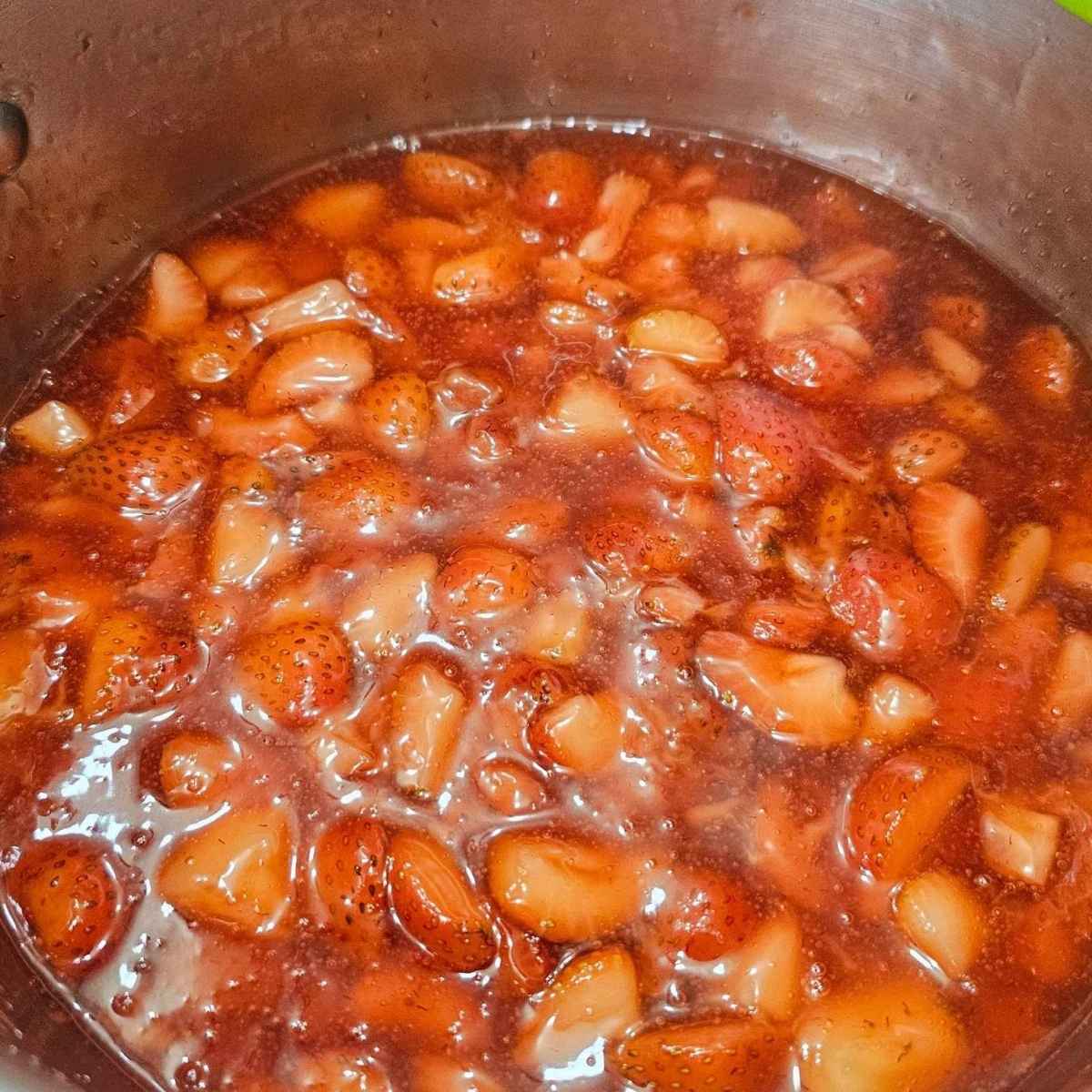 Strawberry sauce being boiled and thickened in the cornstarch slurry