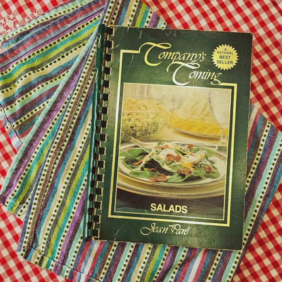 companys coming salads edition 1984 sitting on a red and white table cloth