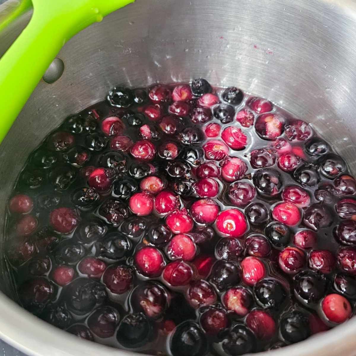 saskatoon berries in a pot with sugar and water