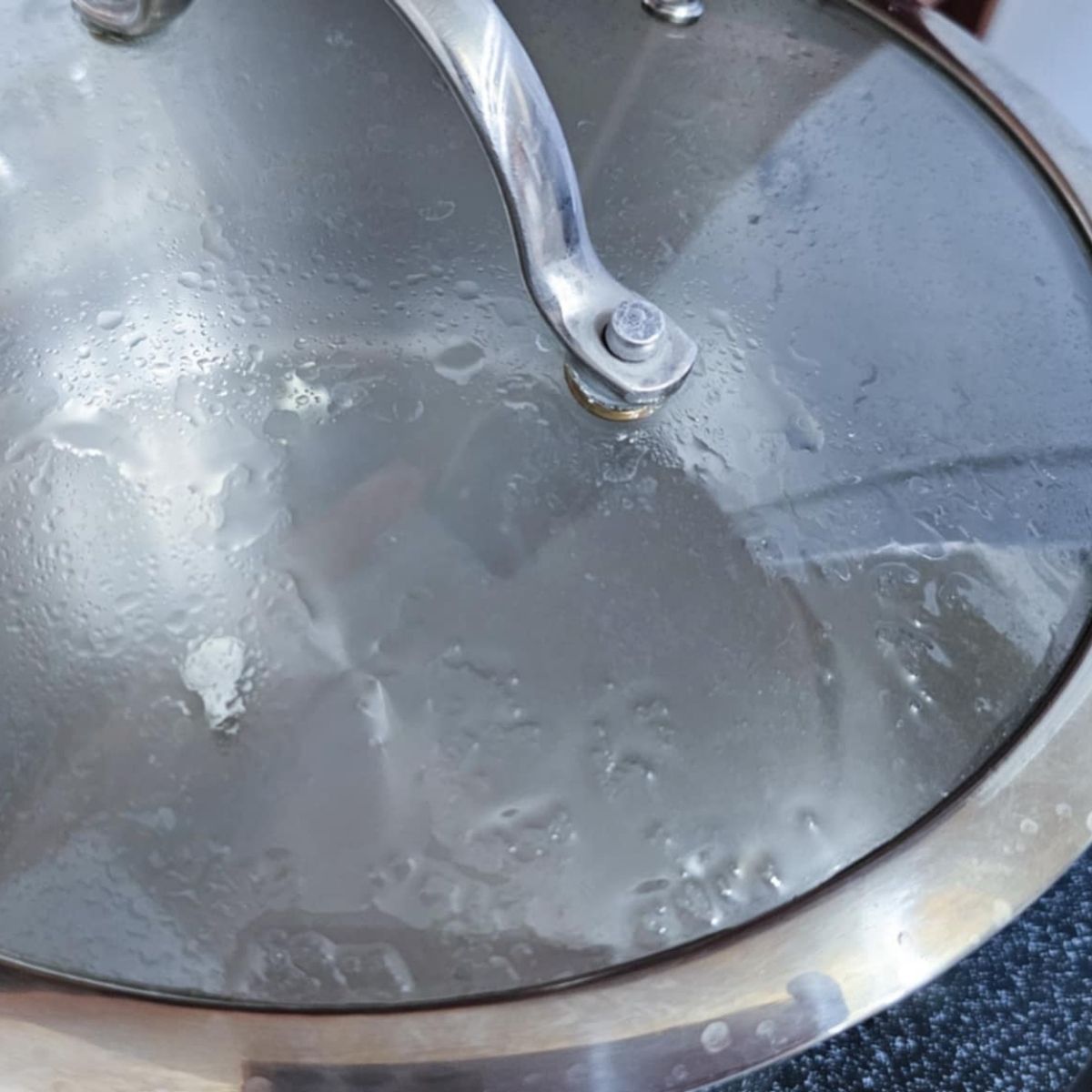 a couple popped kernels in a stainless steel pot