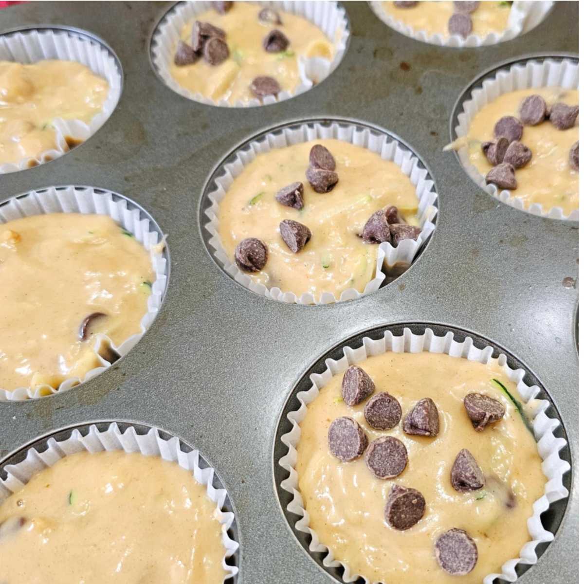 chocolate chip zucchini loaf batter added to the muffin tins and about to go into the oven