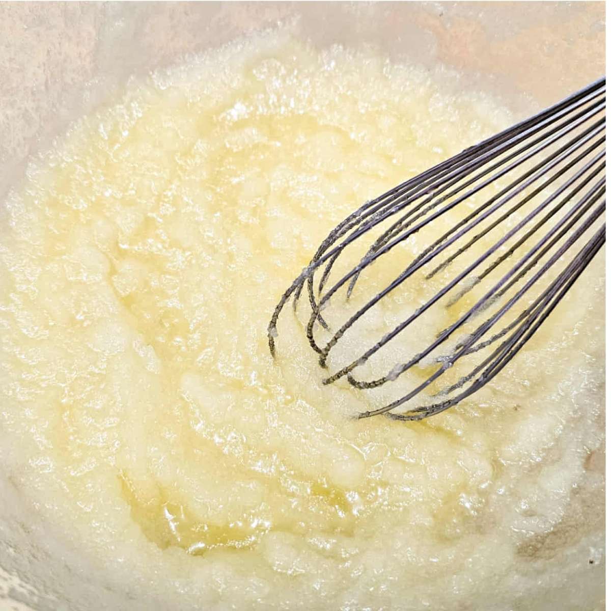 sugar, oil and melted butter in a bowl that was just mixed with a whisk