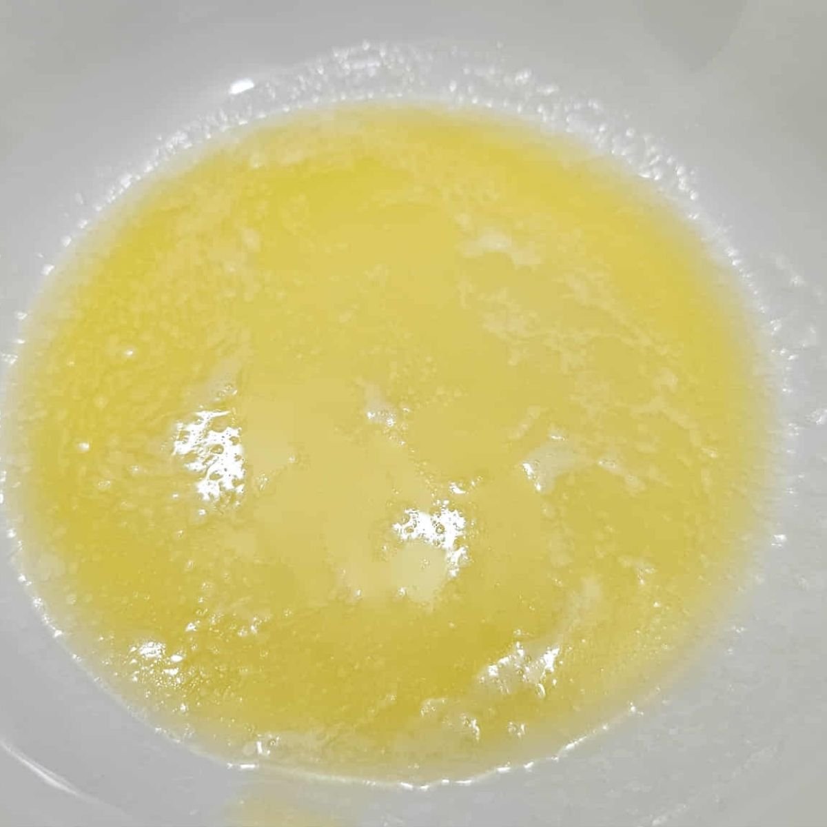 melted butter in a white glass bowl 