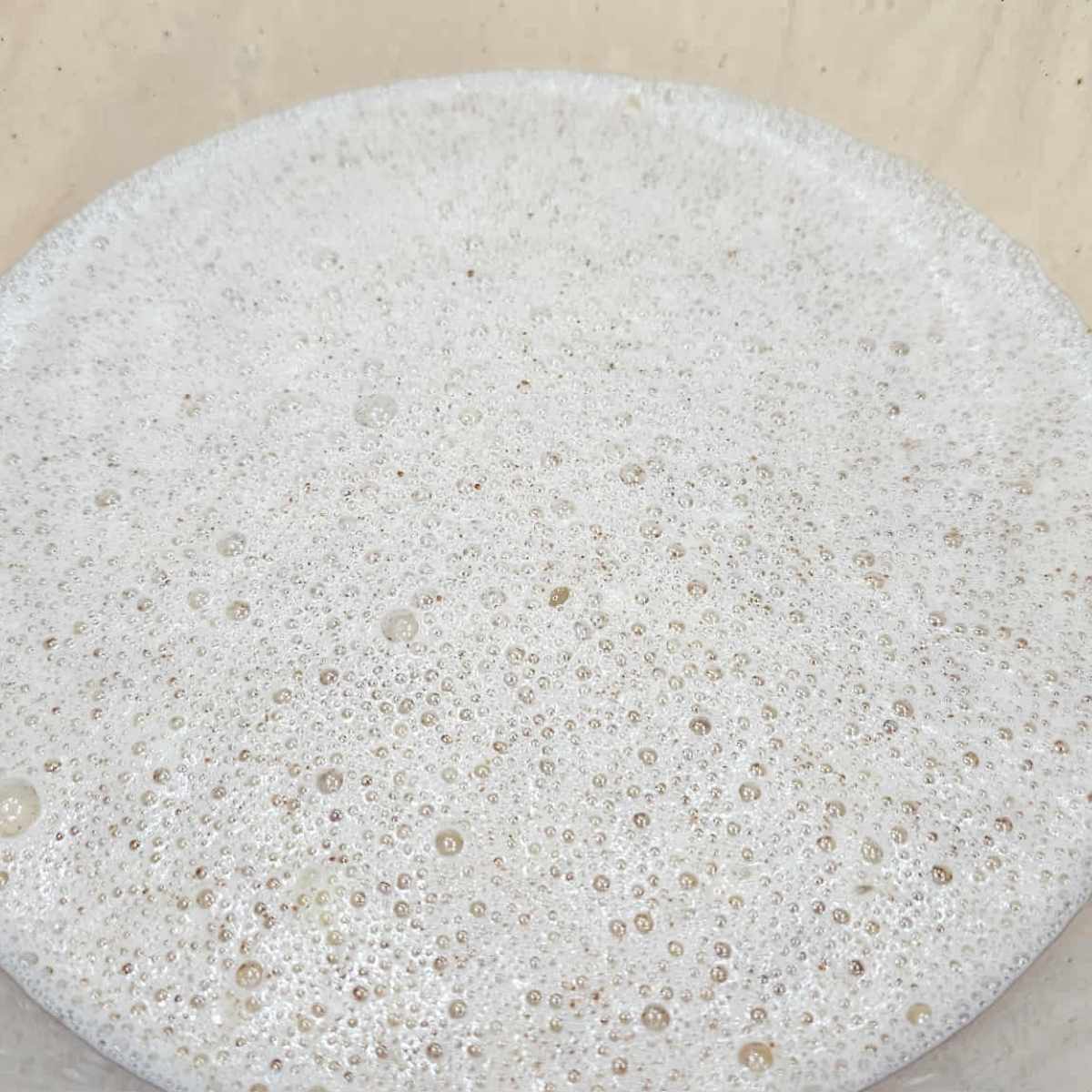 eggs, sugar, cinnamon, milk, vanilla and butter in a bowl that was mixed together and sitting on a wooden counter top