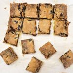 butter tart squares slices and sitting on a piece of parchment paper
