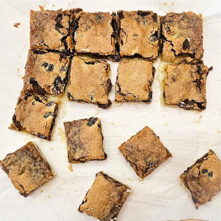 butter tart squares slices and sitting on a piece of parchment paper