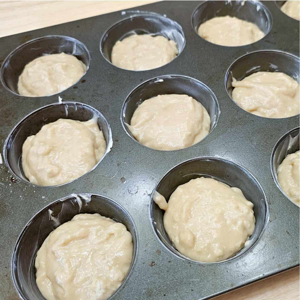 muffin pan filled half way with muffin batter