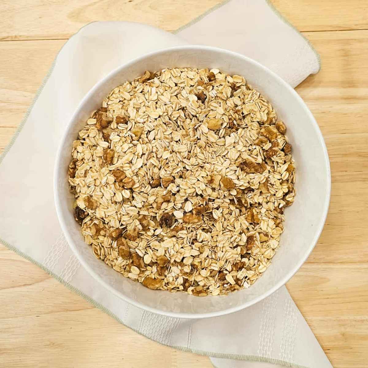 oats and walnuts in a white glass bowl