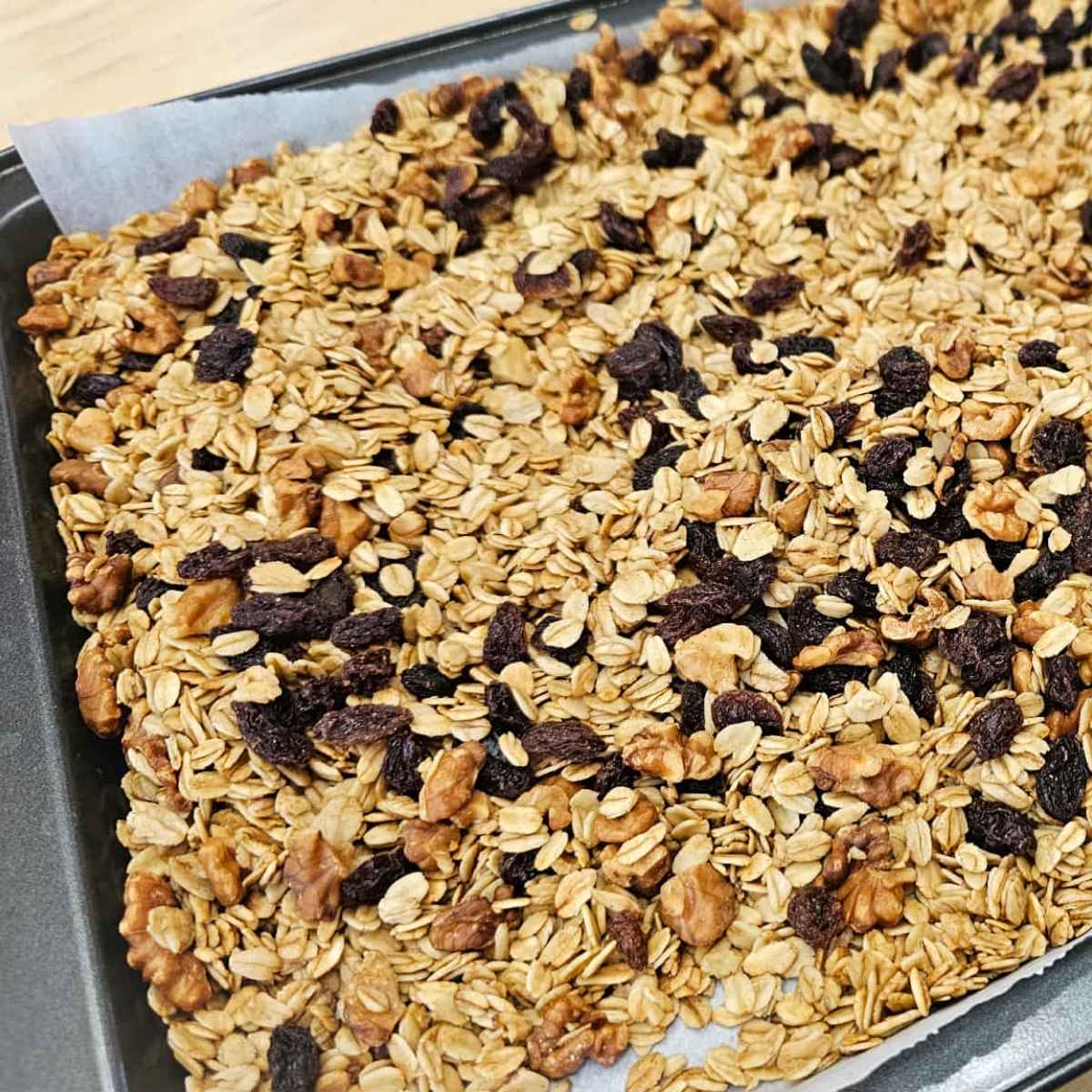 raisins being added to the granola 