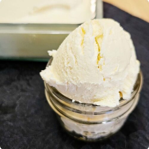 no churn honey ice cream in a small mason jar sitting on a black cloth napkin